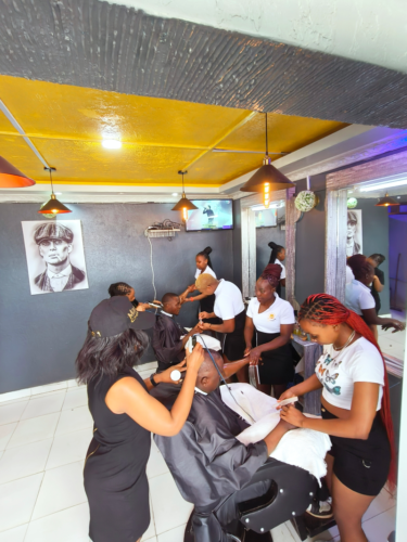 A man happy to receive haircuts by mans chamber female barbers trending in kenya mwende frey